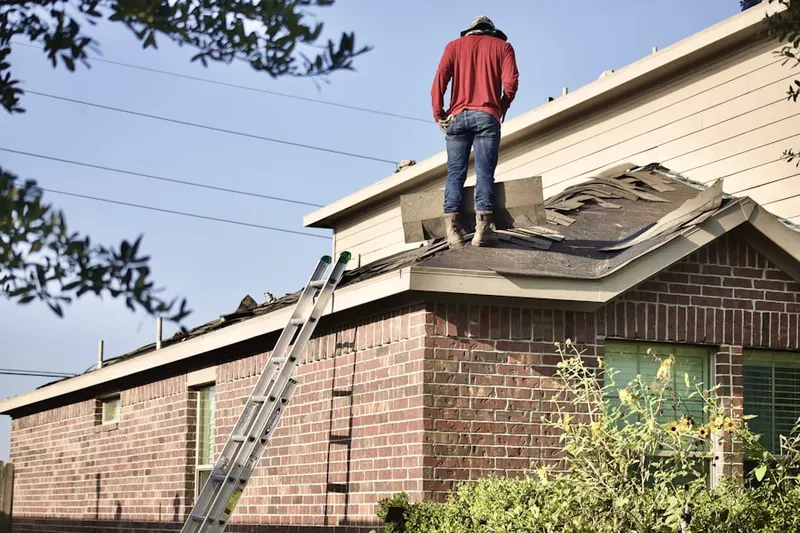 Professional roofer working on a residential roof in Matawan